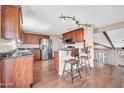 Modern kitchen featuring stainless steel appliances, granite countertops, and dark wood cabinets with breakfast bar at 16805 S 29Th Pl, Phoenix, AZ 85048