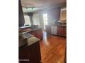 Kitchen featuring stainless steel appliances, granite countertops, and wooden flooring at 16805 S 29Th Pl, Phoenix, AZ 85048