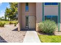 Inviting townhouse entrance, close up, with sidewalk, rock garden, and green shrubbery at 18206 N 45Th Ave, Glendale, AZ 85308