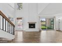 Bright living room with fireplace, wood-look flooring, and high ceilings at 18206 N 45Th Ave, Glendale, AZ 85308
