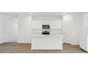Spacious kitchen with a center island, white cabinets, and modern appliances at 18809 E Bruno Dr, Gold Canyon, AZ 85118