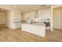 Spacious kitchen with white cabinets, stainless steel appliances, and a large island at 1903 E Empeltre Rd, San Tan Valley, AZ 85140