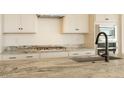 Close-up of the kitchen island featuring a sink, faucet, and granite countertops at 1903 E Empeltre Rd, San Tan Valley, AZ 85140