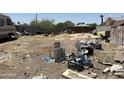 A spacious backyard is filled with discarded furniture, trash, and other unwanted items at 2030 N 21St Pl, Phoenix, AZ 85006