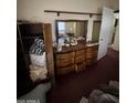 Bedroom with a vintage dresser with mirror, closet and door into a hallway at 2102 W Hazelwood St, Phoenix, AZ 85015