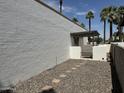 Enclosed backyard featuring a stone pathway and gravel ground cover, offering a private outdoor space at 220 S Old Litchfield Rd # 104, Litchfield Park, AZ 85340