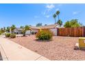Well-kept home with desert landscaping featuring colorful bushes and a low-maintenance gravel yard at 2230 N Los Alamos --, Mesa, AZ 85213