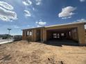 Home under construction showing framing, open garage, and a neighborhood street visible in the background at 2336 E Homesteader Rd, San Tan Valley, AZ 85140