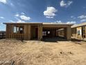 Exterior framing shows the construction progress of this home, highlighting the open layout under a sunny sky at 2336 E Homesteader Rd, San Tan Valley, AZ 85140