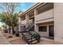 Exterior shot of a condo building with exterior stairwell, landscaping, and sidewalk at 234 N 75Th St # 209, Mesa, AZ 85207