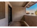 Patio area with neutral toned stucco and modern black door at 234 N 75Th St # 209, Mesa, AZ 85207