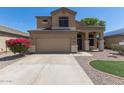 Traditional home offers a spacious driveway, low maintenance landscaping, and inviting covered entry at 24813 W Rosita Ave, Buckeye, AZ 85326
