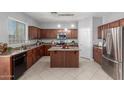 Spacious kitchen features a central island, modern appliances, and ample cabinet space at 24813 W Rosita Ave, Buckeye, AZ 85326