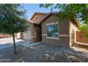 Exterior side view of the home, showcasing the driveway and low-maintenance landscaping at 25447 W Heathermoor Dr, Buckeye, AZ 85326