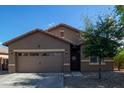 Charming single-story home with a well-maintained front yard and welcoming entryway at 25447 W Heathermoor Dr, Buckeye, AZ 85326