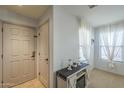 Bright entryway with white walls, beige tile flooring, and large window at 25930 N 165Th Ln, Surprise, AZ 85387