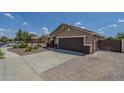 Two-car garage with a brick paver driveway and neutral-toned exterior at 25930 N 165Th Ln, Surprise, AZ 85387