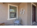 Cozy front porch with seating area, window and decorative wall art at 25930 N 165Th Ln, Surprise, AZ 85387