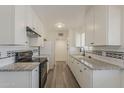 Updated kitchen with white cabinets, granite countertops, and stainless steel appliances at 3202 W Glenrosa Ave, Phoenix, AZ 85017