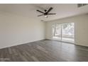 Bright living room with wood floors and sliding glass door to the backyard at 3202 W Glenrosa Ave, Phoenix, AZ 85017