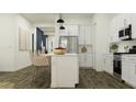 Modern kitchen with white cabinetry, stainless steel appliances, and a convenient island with seating at 32452 N Cherry St, San Tan Valley, AZ 85143