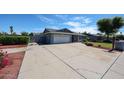 Spacious driveway leading to a well-maintained single-story home, with a manicured front lawn at 3608 W Villa Rita Dr, Glendale, AZ 85308