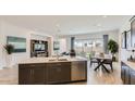 Open layout showcasing a modern kitchen flowing into a well-lit living area with backyard access at 3858 E Kenley Ln, San Tan Valley, AZ 85143