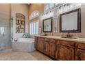 Spa-like bathroom featuring a soaking tub, dual vanities, and elegant fixtures for a luxurious experience at 5077 E Lonesome Trl, Cave Creek, AZ 85331