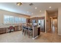 Well-lit kitchen with stainless steel appliances, a center island, and a breakfast bar for casual dining at 5077 E Lonesome Trl, Cave Creek, AZ 85331