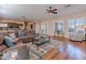 Cozy living room with hardwood floors, plantation shutters, and a comfortable sectional sofa with stylish decor at 5077 E Lonesome Trl, Cave Creek, AZ 85331