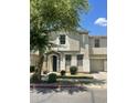 Two-story home featuring a stucco exterior, a stone-accented entrance, and an attached one-car garage at 6614 W Polk St, Phoenix, AZ 85043