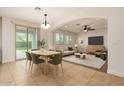 Inviting living and dining area with an open concept, neutral tones, and sliding glass door leading to backyard at 6632 W Saguaro Park Ln, Glendale, AZ 85310
