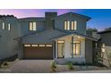Beautiful two-story home with a modern design, visible in the evening light with illuminated windows at 6722 N 9Th Dr, Phoenix, AZ 85013