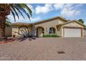Inviting single-Gathering residence with arched entryway, two-car garage, and low maintenance desert landscaping at 811 S 79Th Way, Mesa, AZ 85208
