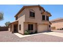Two-story stucco home with a two-car garage, desert landscaping, and a covered front porch at 9243 W Palmer Dr, Peoria, AZ 85345