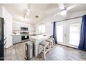 Bright eat-in kitchen with wood-look tile flooring, modern cabinetry, stainless appliances and a kitchen island at 9243 W Palmer Dr, Peoria, AZ 85345