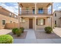 Charming home featuring a covered porch, balcony, and desert-friendly landscaping at 925 E Agua Fria Ln, Avondale, AZ 85323