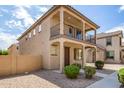 Two-story home boasting a balcony and a well-maintained desert landscape at 925 E Agua Fria Ln, Avondale, AZ 85323