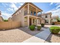 Attractive two-story home showcases a balcony with desert landscaping at 925 E Agua Fria Ln, Avondale, AZ 85323