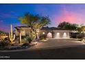 Charming single-story home with beautiful desert landscaping enhancing the curb appeal and design at 9675 E Roadrunner Dr, Scottsdale, AZ 85262