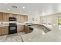 Spacious kitchen features granite countertops, oak cabinets, and stainless steel appliances at 1072 W Windhaven Ave, Gilbert, AZ 85233
