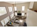 Two-story living room with neutral colors, large windows, and plenty of natural light at 1072 W Windhaven Ave, Gilbert, AZ 85233