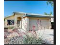 Charming single-story home with a well-manicured front yard and a two-car garage, and covered entry way at 13280 W Caribbean Ln, Surprise, AZ 85379
