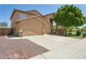Spacious stucco home featuring a three-car garage, and ample driveway parking at 13724 W Luke Ave, Litchfield Park, AZ 85340