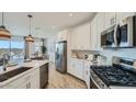 Modern kitchen featuring stainless steel appliances and white cabinets at 1516 W Ridge Rd, Apache Junction, AZ 85120