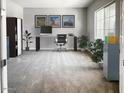 Spacious home office with a large window, a work desk, and ample storage options at 16035 W Questa Dr, Surprise, AZ 85387