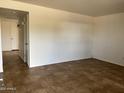 A bright living room features tile flooring and a neutral color palette for versatile styling options at 1714 W Villa Rita Dr, Phoenix, AZ 85023