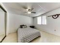 Cozy bedroom featuring wood-look flooring, a ceiling fan, and mirrored closet doors at 17200 W Bell Rd # 47, Surprise, AZ 85374