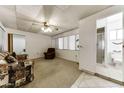 View of the living room showing a sofa, carpet, access to the bathroom and the bedroom at 17200 W Bell Rd # 47, Surprise, AZ 85374
