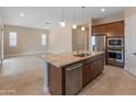Open-concept kitchen features granite countertops, stainless steel appliances, and a large island with seating at 17886 W Brookwood Dr, Goodyear, AZ 85338